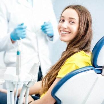 Young woman in dental chair grinning