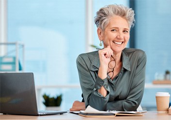 Woman smiling at her desk
