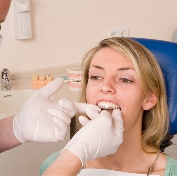 Dentist fitting a patient with Invisalign clear aligners in Waco