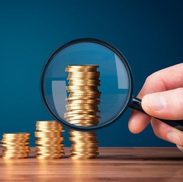 Stacks of coins examined with magnifying glass