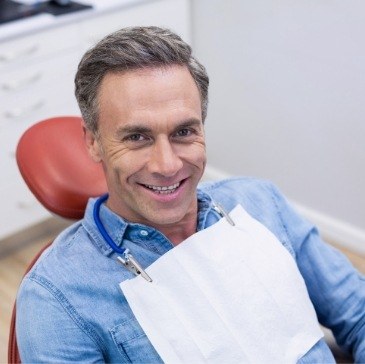 Smiling older man in dental chair