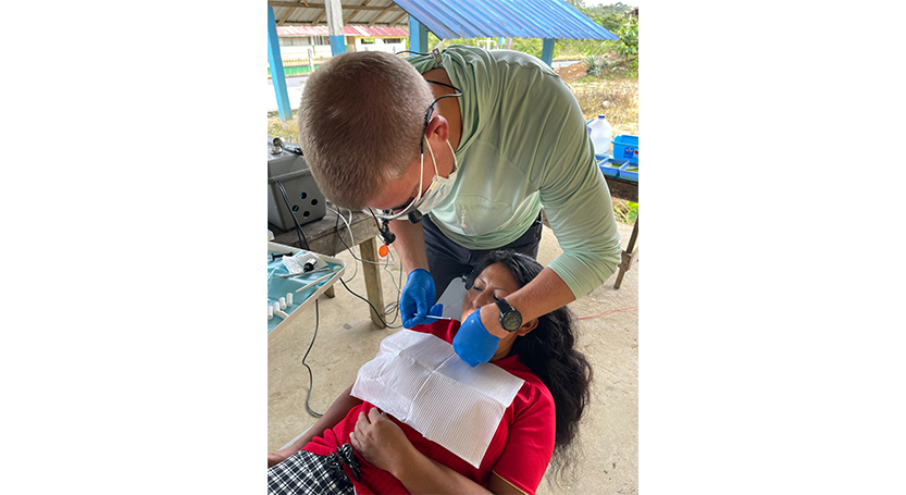 Doctor Cofer treating a dental patient at Waco community event