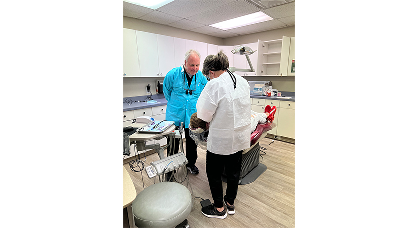 Doctor Cofer and dental team member treating a dental patient