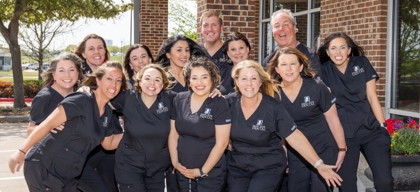 Waco dentists and team members smiling outside of Premier Family Dental