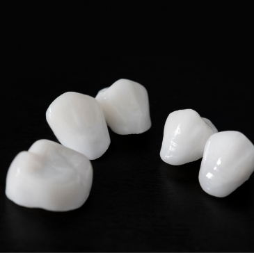 Two metal free dental restorations against black background