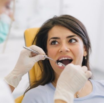 Dental patient opening her mouth for dental exam
