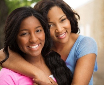 Mother and daughter hugging