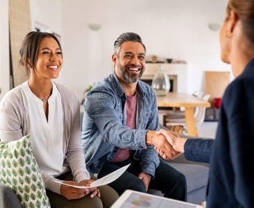 Man shaking hands with dental team member