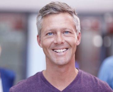 Smiling man in purple T shirt