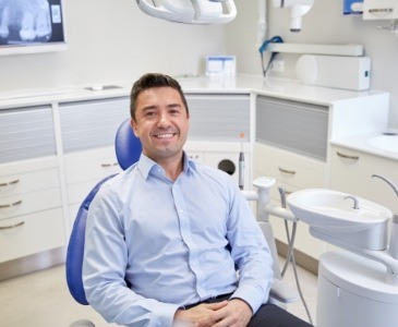 Smiling man sitting in dental chair