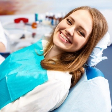 Young woman grinning in dental chair