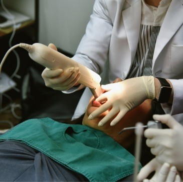 Dentist taking digital dental impressions of a patient