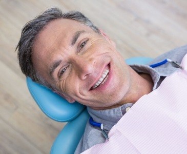 Smiling man leaning back in dental chair