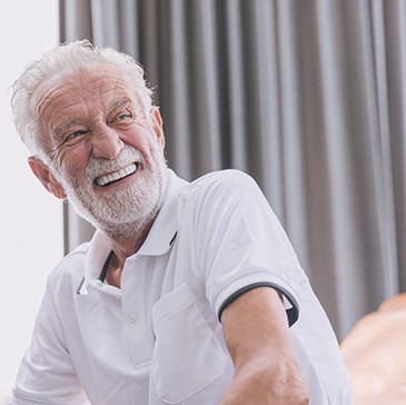 Man smiling on a couch