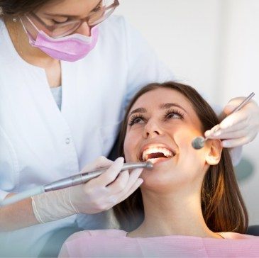 Woman smiling at her dentist during emergency dental visit