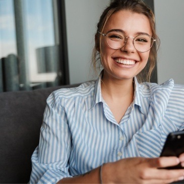 Smiling woman holding cell phone