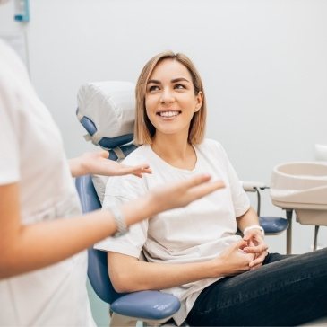 Woman in dental chair smiling at her Waco dentist