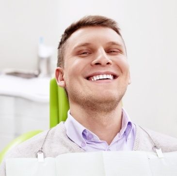 Man grinning in dental chair