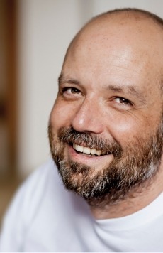 Smiling man with shaved head