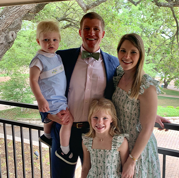 Doctor McNutt with his family at formal outdoor event