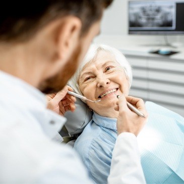 Senior woman smiling at dentist