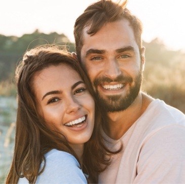 Man and woman smiling outdoors