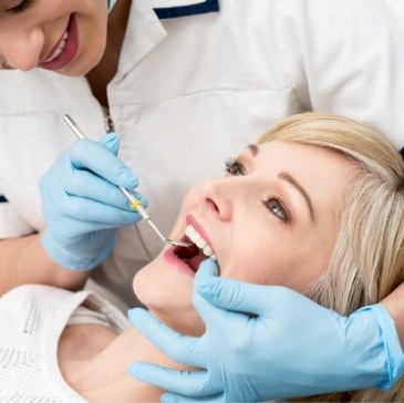 Blonde woman receiving dental exam