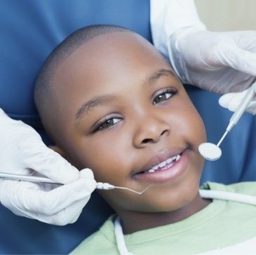 Young boy smiling in dental chair