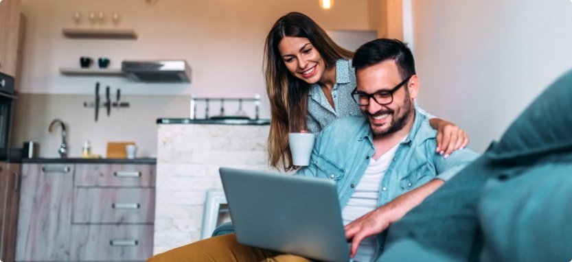 Man and woman looking at laptop reading dentist reviews in Waco