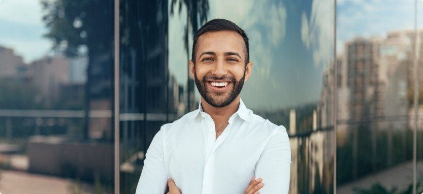 Smiling man in white dress shirt outdoors after sedation dentistry in Waco