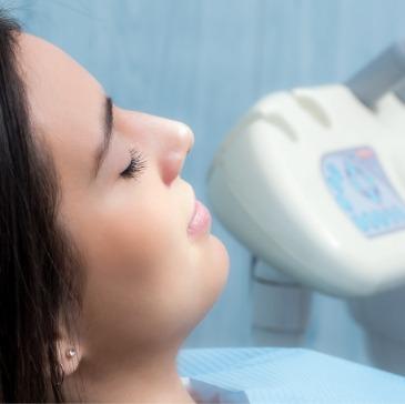 Woman relaxing in dental chair with eyes closed