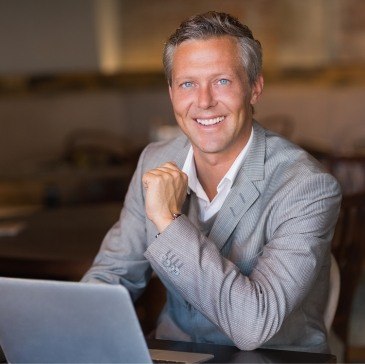 Businessman sitting at desk with laptop