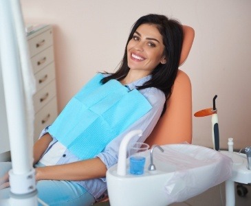 Smiling woman sitting back in dental chair