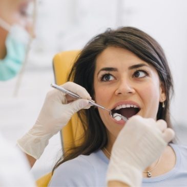 Dentist performing a dental exam on a patient