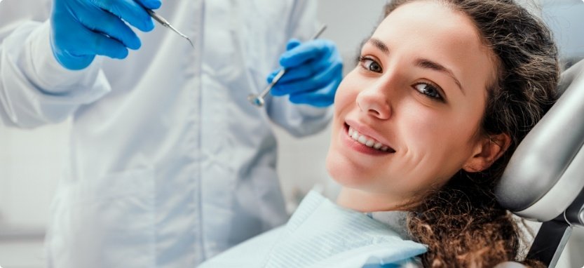 Woman smiling while visiting her United Healthcare dentist in Waco