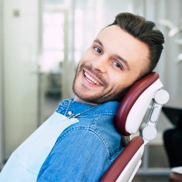 Smiling man leaning back in dental chair