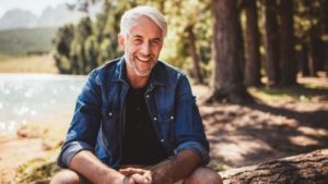 mature man smiling outdoors 