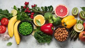 fresh fruits and vegetables arranged on a countertop 