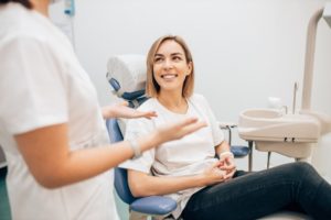 cosmetic dentist talking with patient in waco