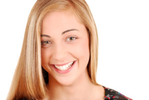 blonde woman smiling with perfect teeth