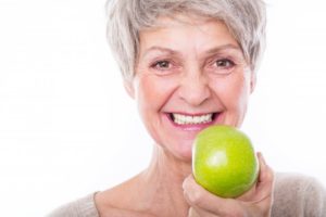 older woman preparing to eat apple