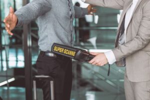 Man getting scanned with metal detector in airport 