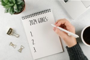 a person making a list titled "2024 Goals"