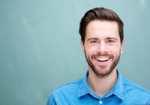 young man smiling with teeth fully restored thanks to Waco CEREC