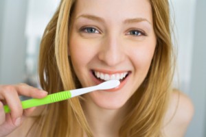 woman brushing teeth with the toothbrush the waco dentist recommends