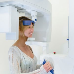 A woman inside a cone beam scanner.