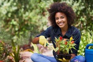 Woman with a beautiful smile planting healthy foods recommended by the waco dentist