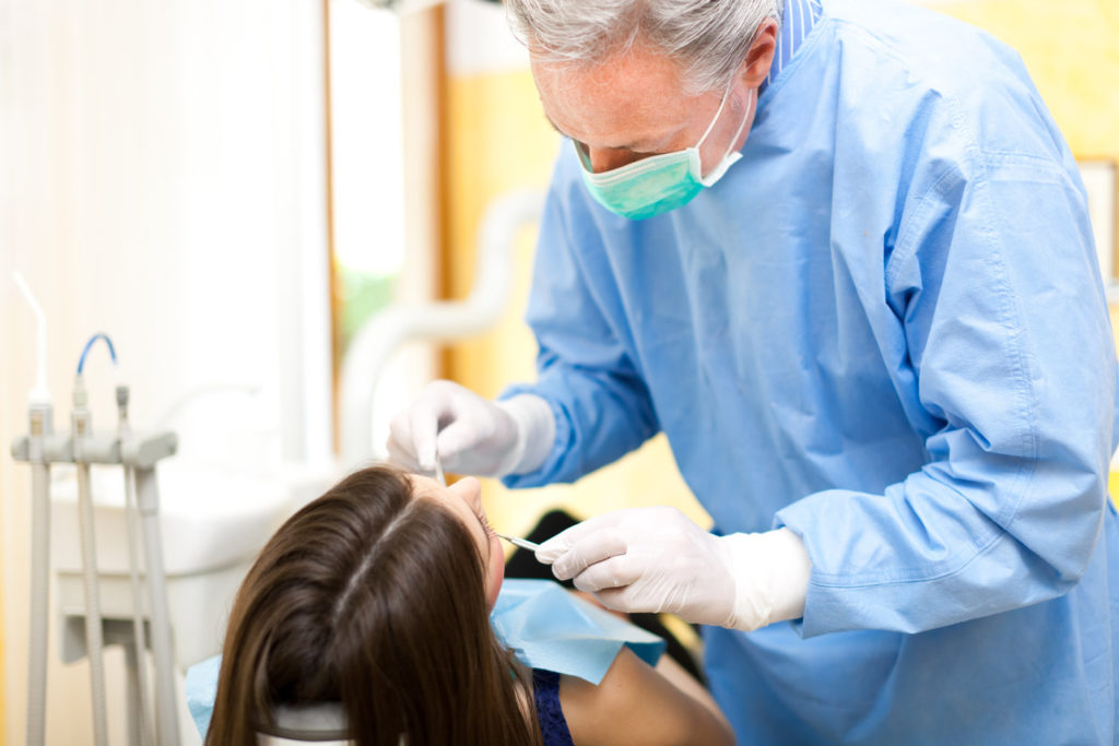 A dentist performs root canal therapy in Waco